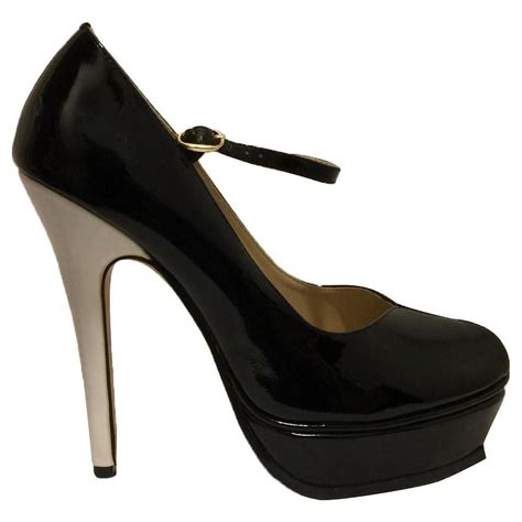 Yves Saint Laurent Tribute Mary Janes in black patent White.